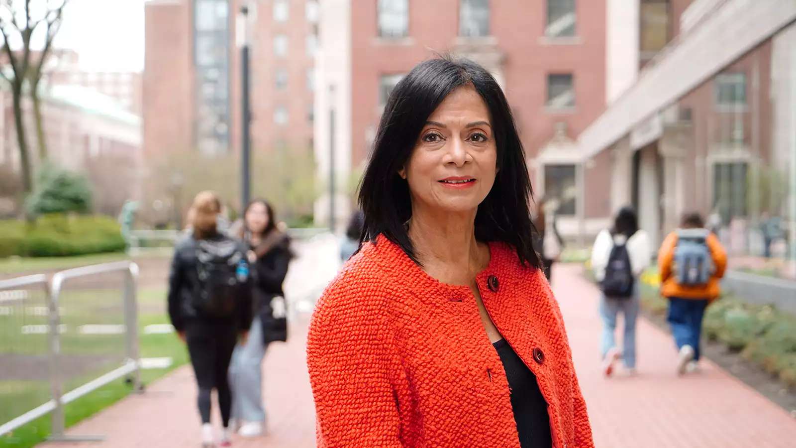 Akosua-Barthwell-Evans-’68 in a red jacket on Barnard campus